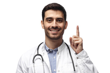 Smiling male doctor with stethoscope pointing finger up showing idea or important information
