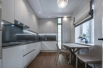 Modern kitchen design with elegant furniture and stylish lighting in a bright environment.