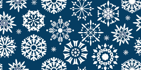 A seamless pattern of delicate white snowflakes on a deep navy background