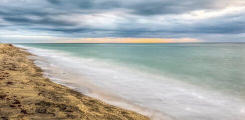 Late afternoon with dramatic clouds in sky over the Gulf of America  formally the Gulf of Mexico at the Venice Fishing Pier in Venice Florida USA