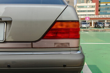 Fototapeta premium Elegant car detail showcases sleek lines and a captivating taillight design.