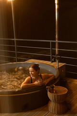 Relaxing evening in a hot tub on a balcony at night