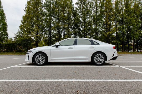 October 11, 2020, Seoul, South Korea - A white Kia K5 sedan parked in an outdoor parking lot.
