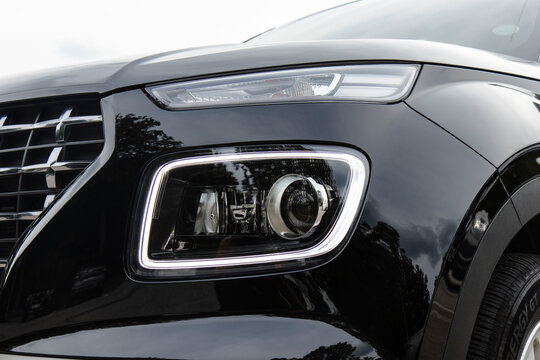 October 4, 2020, Seoul, South Korea - A close-up view of the headlight and front grille of a black Hyundai Venue.
