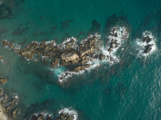 Stunning Aerial View of a Rocky Coastal Landscape Surrounded by Beautiful Turquoise Waters
