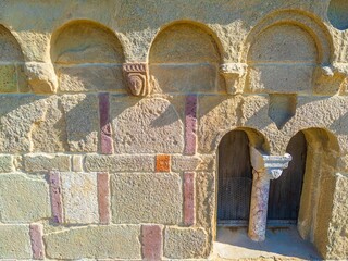 Romanesque stone fa&ccedil;ade detail with arches and small doorway. Church of Santa Maria di Sibiola in Serdiana, Sardinia, Italy
