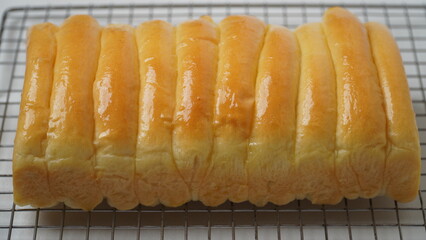 Freshly cooked golden brown comb bread is served on a cooling rack placed in a white place (isolated white).