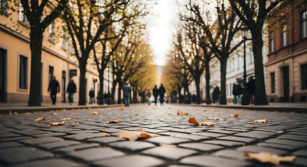 Golden autumn light illuminates a historic cobblestone street, capturing people enjoying a serene city stroll