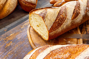 Fresh homemade baked bread sliced a on rustic wooden cutting board