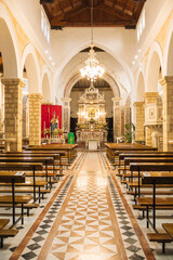 Fototapeta premium Ornate church interior with symmetrical aisle and decorated altar