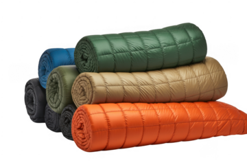 Rolled sleeping bags in orange green beige blue gray isolated on a transparent background