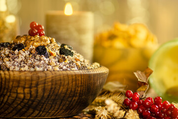 Festive Ukrainian Christmas grain dish with wheat, poppy seeds, walnuts, and dried fruits in rustic bowl. Traditional food composition reflects Ukrainian