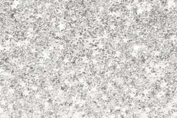 Shimmering silver star confetti background for celebrations and festive occasions.