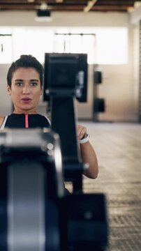 Workout, rowing machine and woman in gym for energy, wellness or sports for body health. Health club, person and exercise on ergometer for fitness, muscle strength or core training for cardio