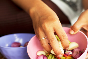 Handheld Bowl of Spicy Cooking Ingredients