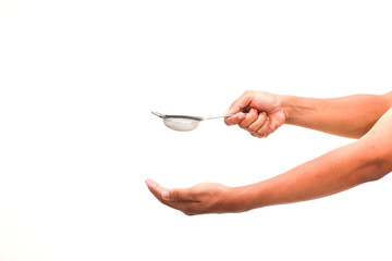 Close-up of Hands Holding a Fine Mesh Strainer Against a Bright White Background