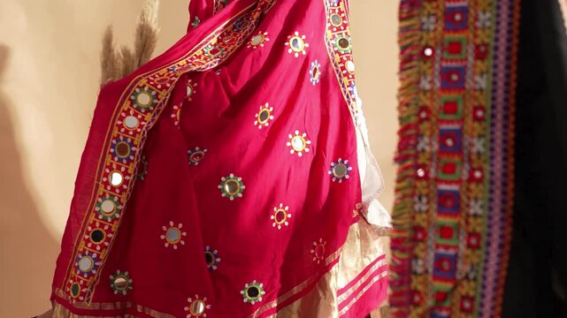 Shot of Indian woman draping red Jaipuri saree on shoulder captured in detailed 4K footage highlighting traditional attire, cultural elegance