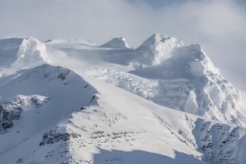 Snow covered mountain peaks near Krysuvik, Iceland.