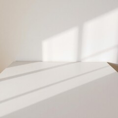 Empty bright room with natural light casting geometric shadows on the floor and wall