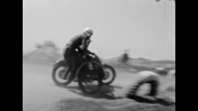 Extreme motorcycle racing. Thrilling sidecar motorcycle race on dirt track, competitors skillfully navigating dusty curve in front of spectators. Old film. Archival retro 1960s. Vintage archive.