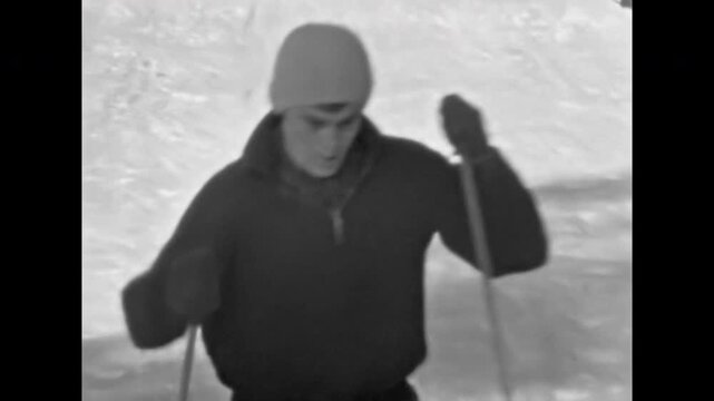 Men actively climb snowy slope on skis. Active lifestyle in winter. People skiers enjoy sports vacation in mountains. Travel adventure in holidays. Old film. Archival retro 1960s. Vintage archive