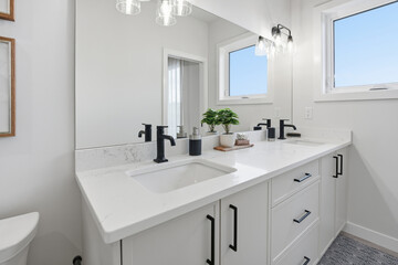 Bathroom with a white sink and a black faucet