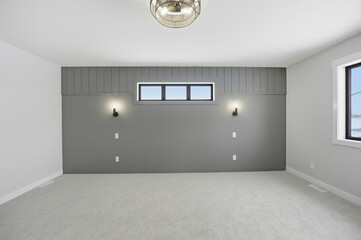 Bedroom with a grey wall and a grey carpet
