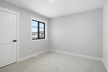 Bedroom with a white door and a window