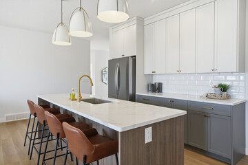 Kitchen with a white counter and a black and brown bar