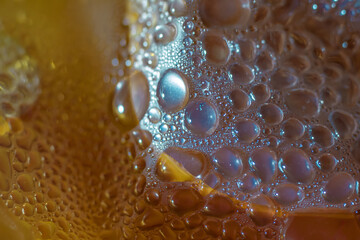 Water droplets on the surface of polyethylene film with colored lighting