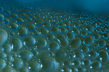 Water droplets on the surface of polyethylene film with colored lighting