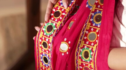 Close up of Indian woman draping red Jaipuri saree in 4K, showing traditional fabric, elegant drape, rich texture, and cultural craftsmanship, ideal for fashion and cultural visuals. - Powered by Adobe