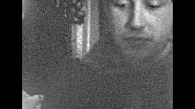 Old film, Serious woman, man portrait indoor, close up. Female looks at male with serious expression on face. Guilty guy averts eyes, trying not to make eye contact. Archival retro. Vintage archive.