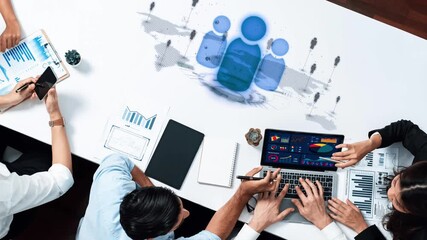 A diverse business team engages in data analysis and visualization, collaborating with laptops, charts, and strategic discussions in a modern office setting. Raster - Powered by Adobe