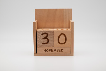 Wooden desk calendar showing 30th November, symbolizing time pressure, planning, productivity, and end-of-month business tasks.