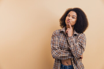 African American woman thinking, hand on chin, doubt concept