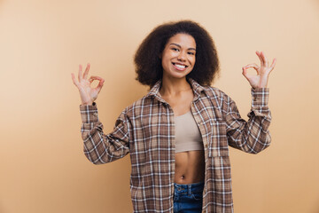 African American woman smiling making OK gesture