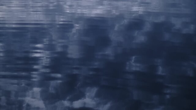 Abstract underwater light caustics and rippling water surface