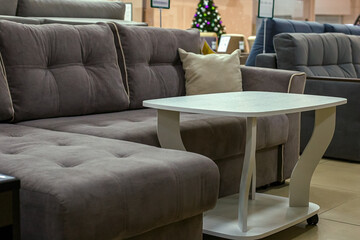 A modern sofa in the interior of a furniture showroom.
