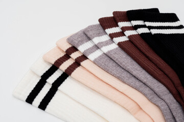 Colorful knitted scarves with stripes on white background