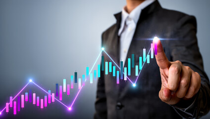A businessperson points at a glowing financial chart showing upward growth and market success.