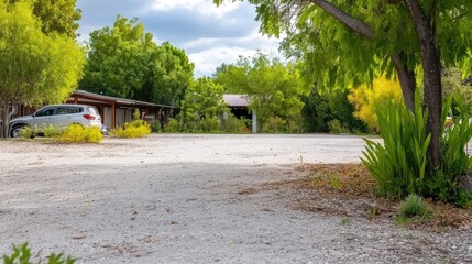 Fototapeta premium Idyllic rural parking area with vibrant greenery surrounding in the sunny day
