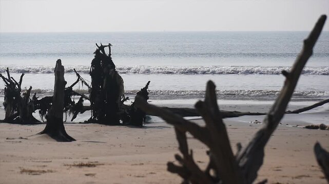 Fisherman boat parked and tossed around by sea wave, fishing boat on the sea wave beach with blue sky in India.