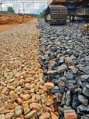 Part of the road construction site with a large number of stones.