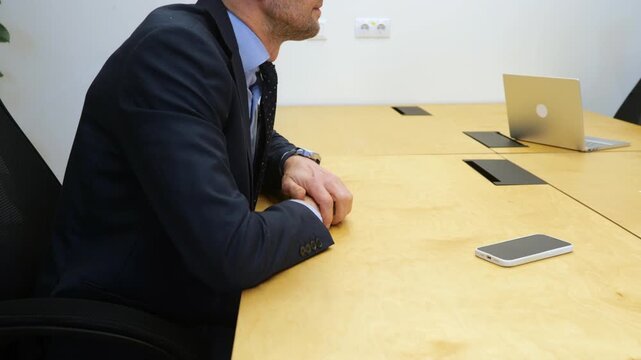 Businesswoman conducting job interview with middle age male, man looks nervous