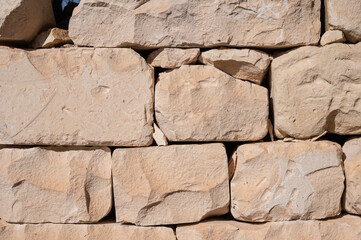 Stacked ochre-colored rough rocks, usable as background, near the coastal village of Marsaxlokk Marsaxlokk, Malta, 6 DEC 2025.