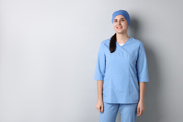 Doctor in medical uniform on white background, space for text