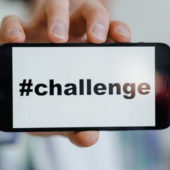 The picture shows the word 'challenge' on the cellphone.