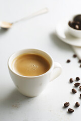 Minimalist coffee cup on white background with coffee beans, ideal for modern cafe, branding and lifestyle concepts