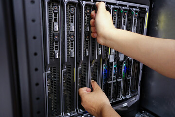 Hands Operating Data Server in Server Rack